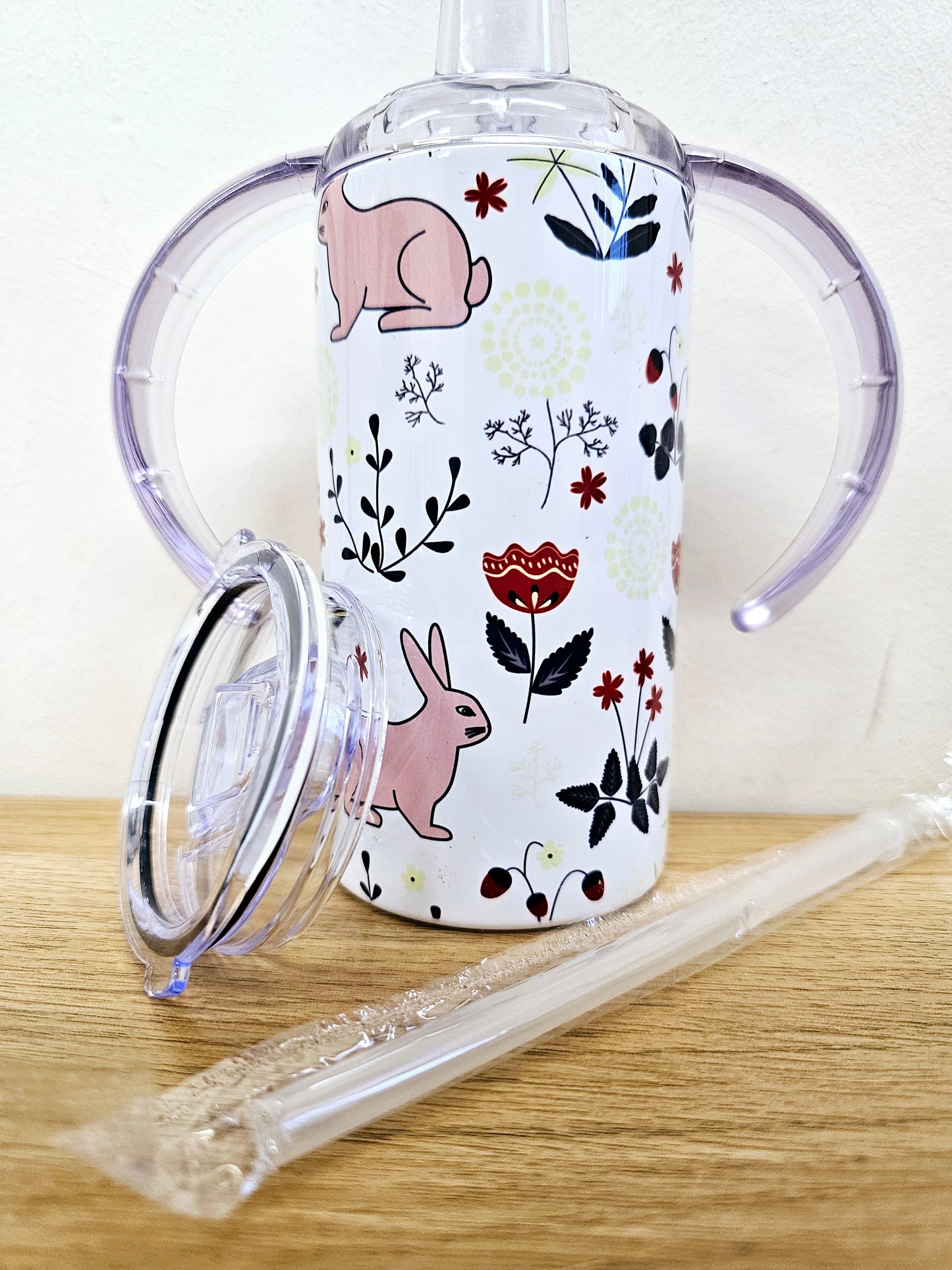 Sippy cup tumbler 12oz with double handle and straw lid rabbit and floral design.