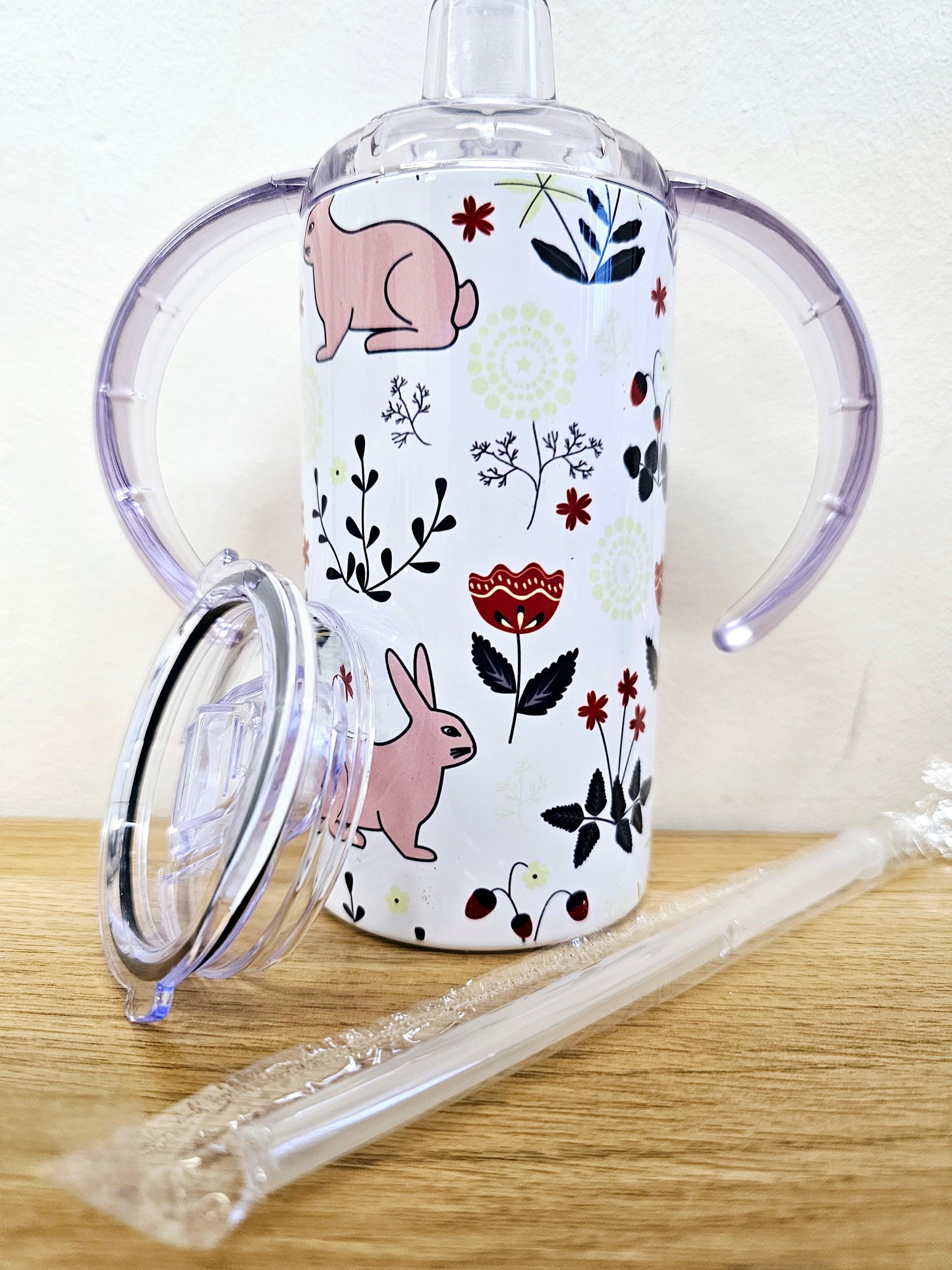 Sippy cup tumbler 12oz with double handle and straw lid rabbit and floral design.